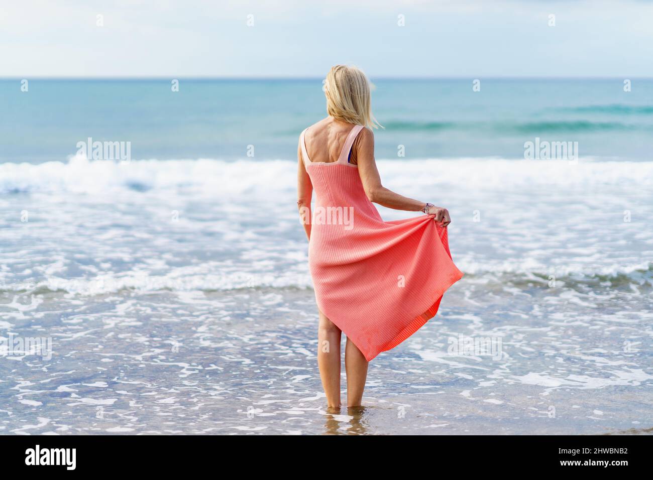 Mature woman enjoying herself on the beach Stock Photo - Alamy