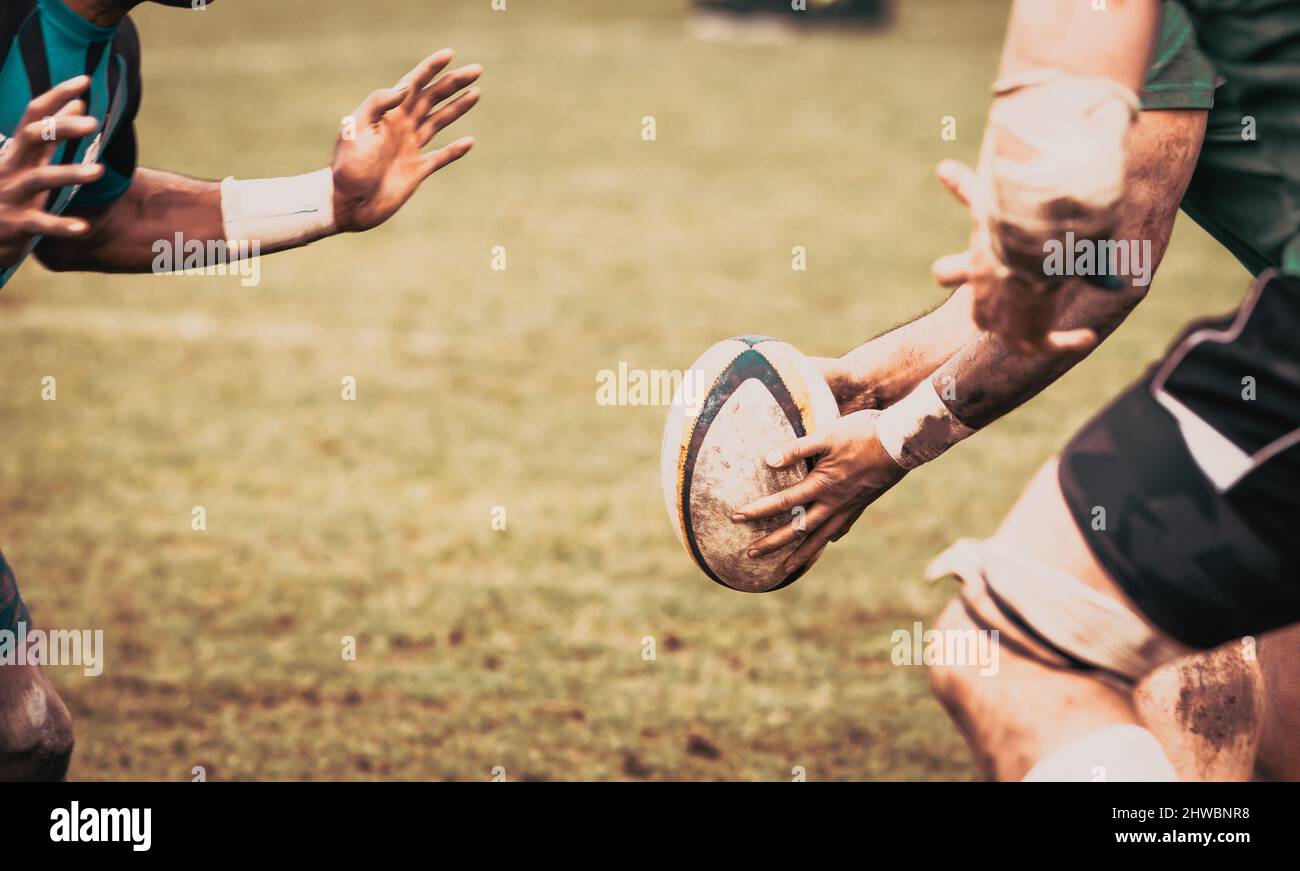 rugby player preparing to kick the oval ball during game Stock Photo