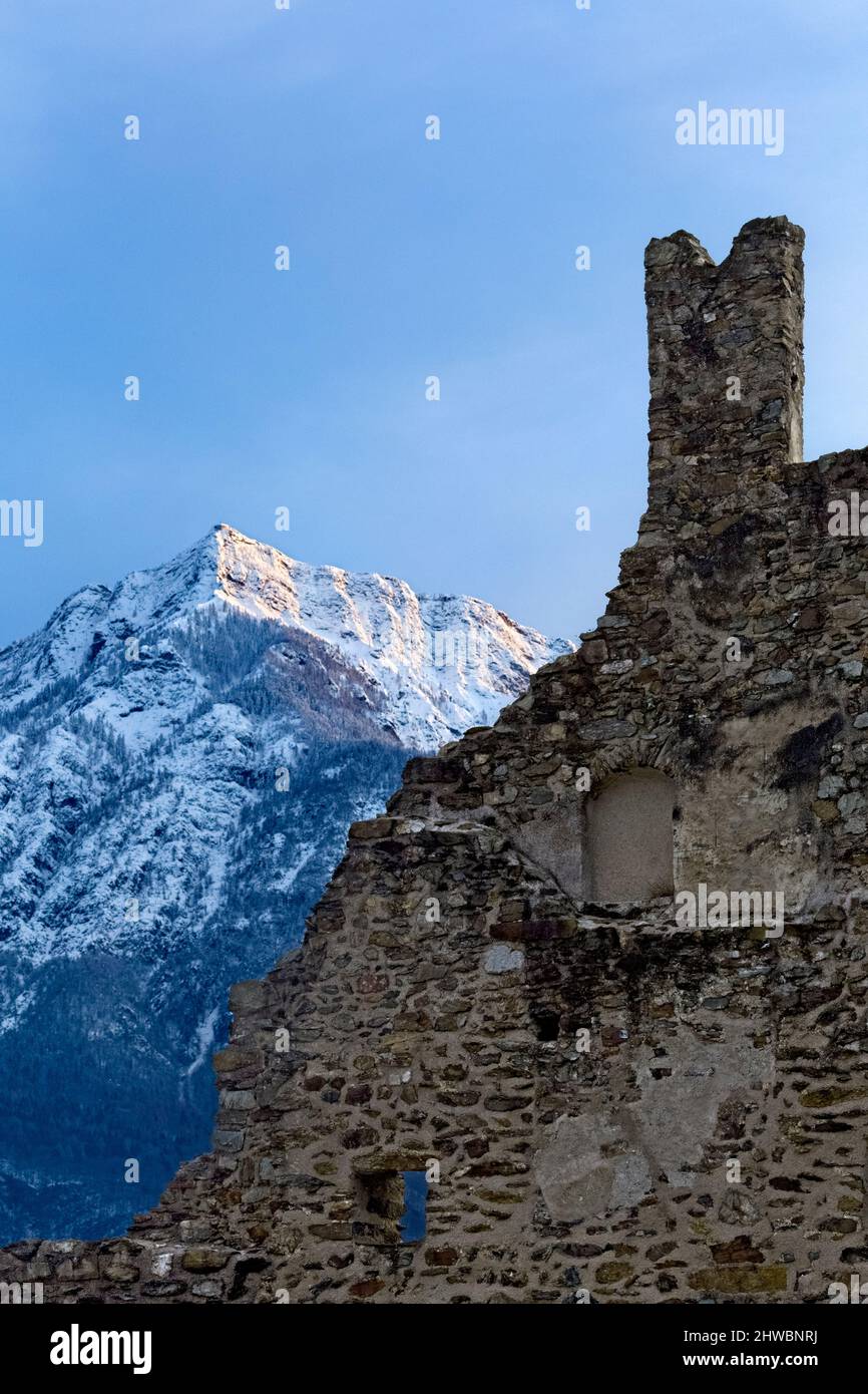 The crenellated ruins of Selva Castle and mount Cima Vezzena in winter. Levico Terme, Trento province, Trentino Alto-Adige, Italy, Europe. Stock Photo