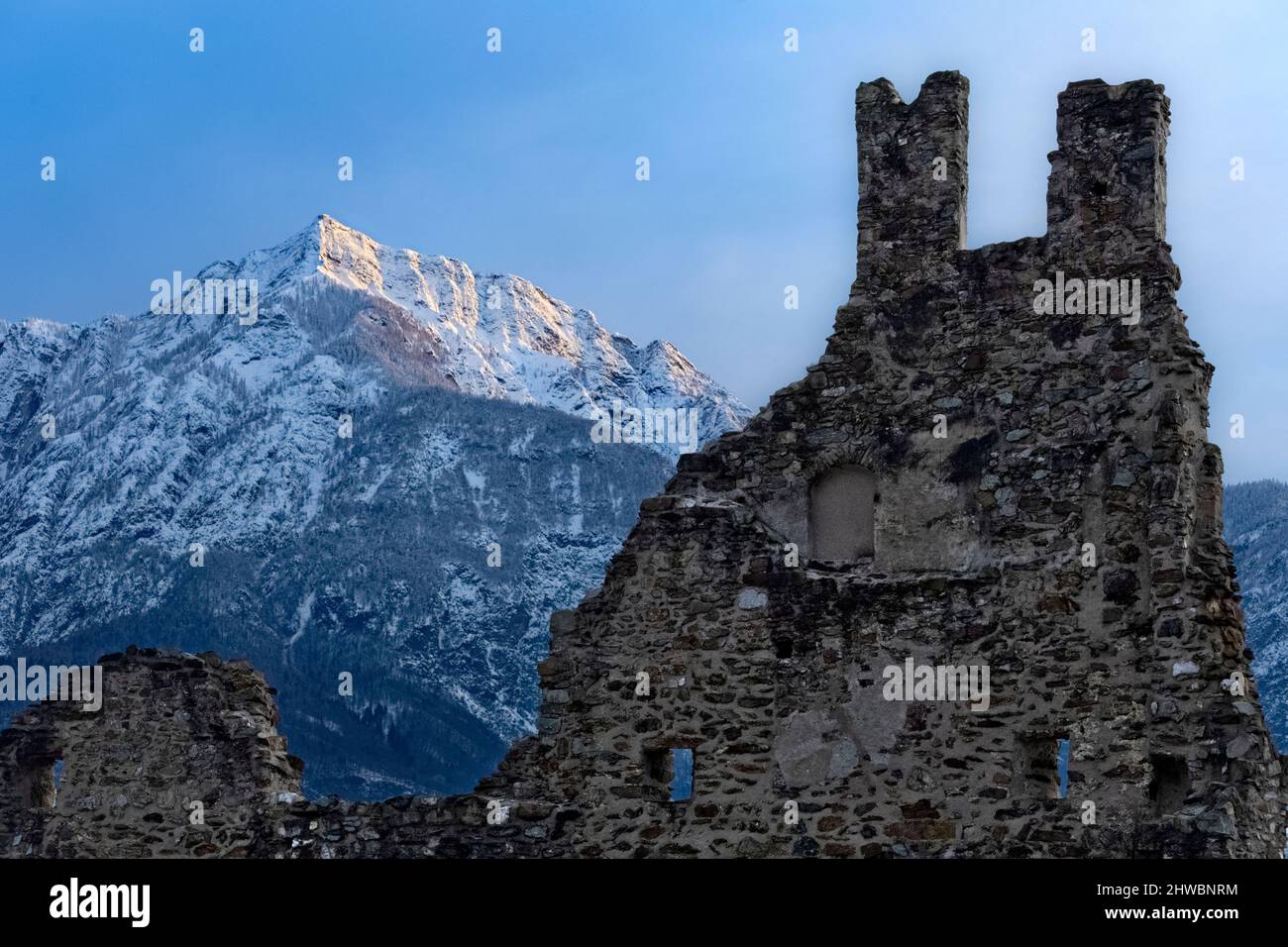 The crenellated ruins of Selva Castle and mount Cima Vezzena in winter. Levico Terme, Trento province, Trentino Alto-Adige, Italy, Europe. Stock Photo