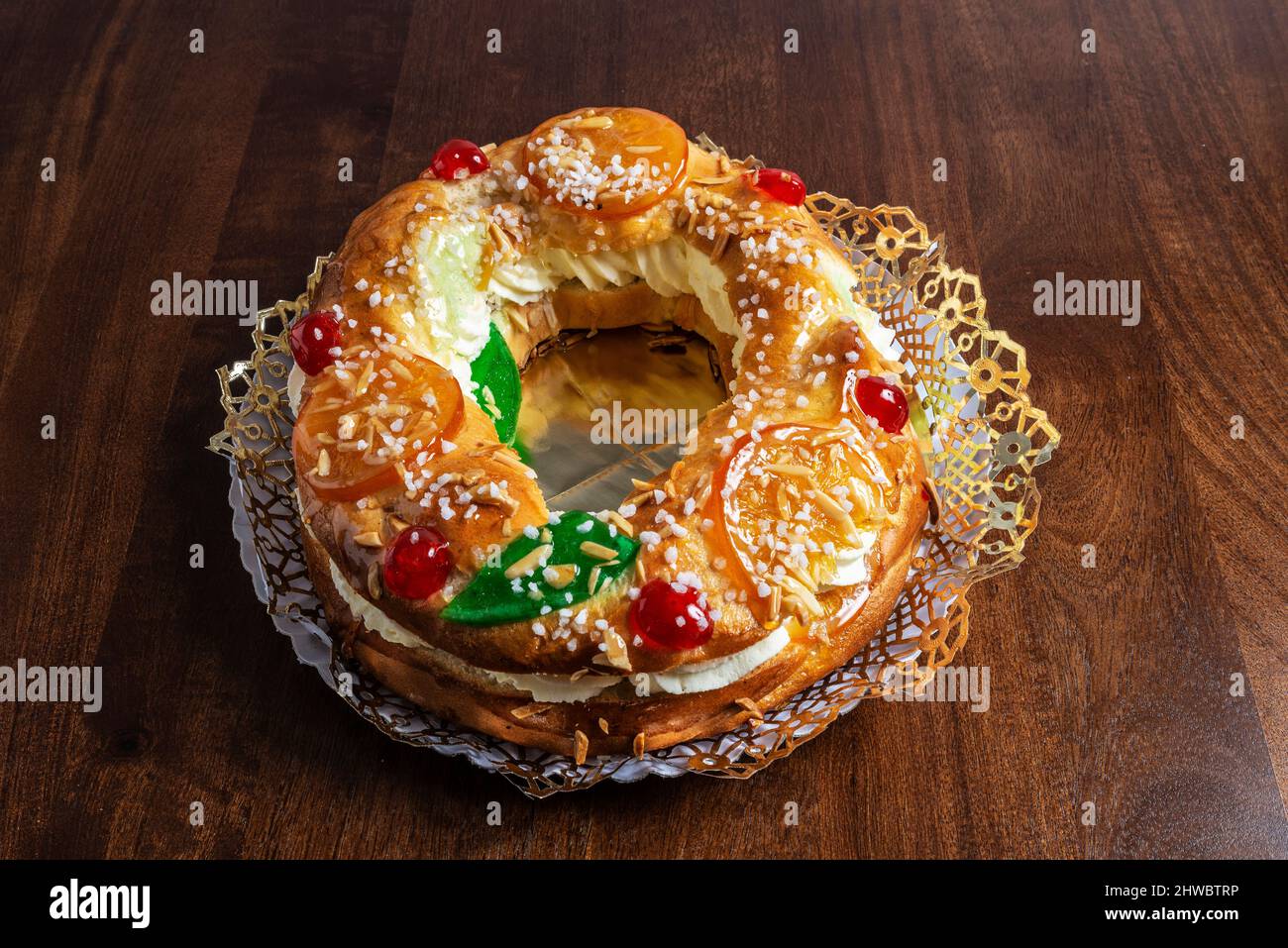 Tortell de reis or king cake is a typical cake of Catalan and Occitan cuisine in the form of a ring or hoop, made of brioche dough, puff pastry and fi Stock Photo