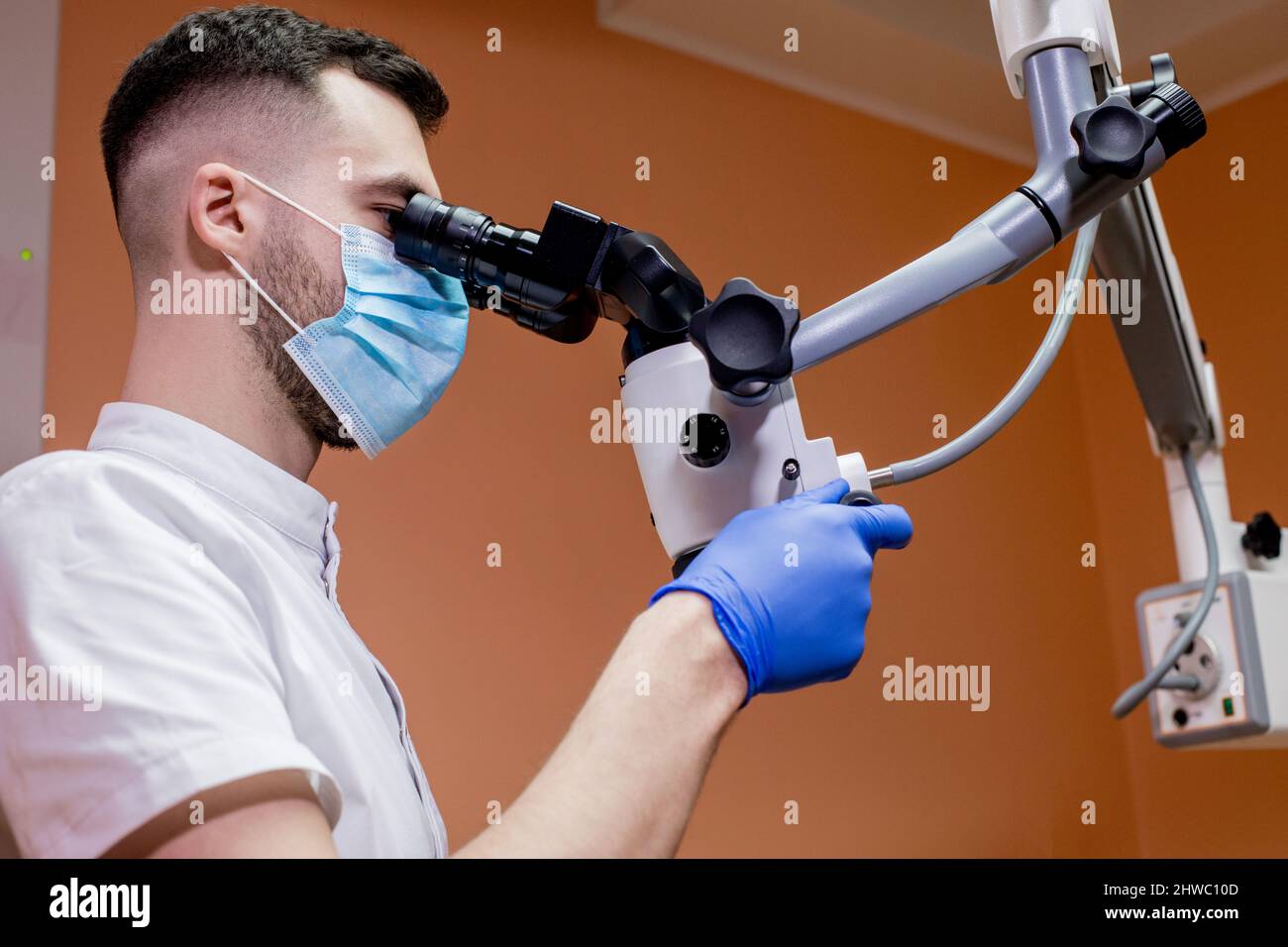 A young scientist conducting research with a microscope. Working with a microscope. Stock Photo