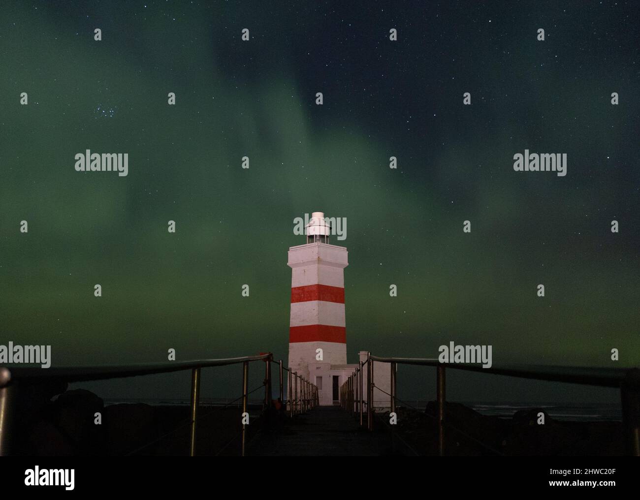 Northern lights over Garður lighthouse & churches Stock Photo Alamy