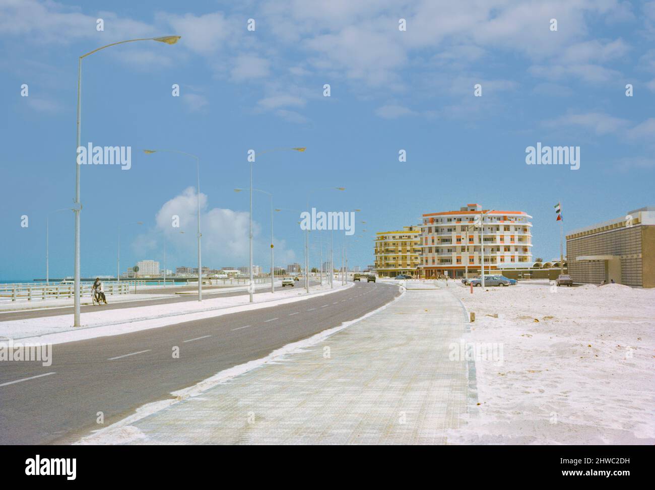 Abu Dhabi, UAE.  Corniche Street Scene. Persian (Arabian) Gulf off to left side. Abu Dhabi begins its modern development. Photographed March 1972. Stock Photo