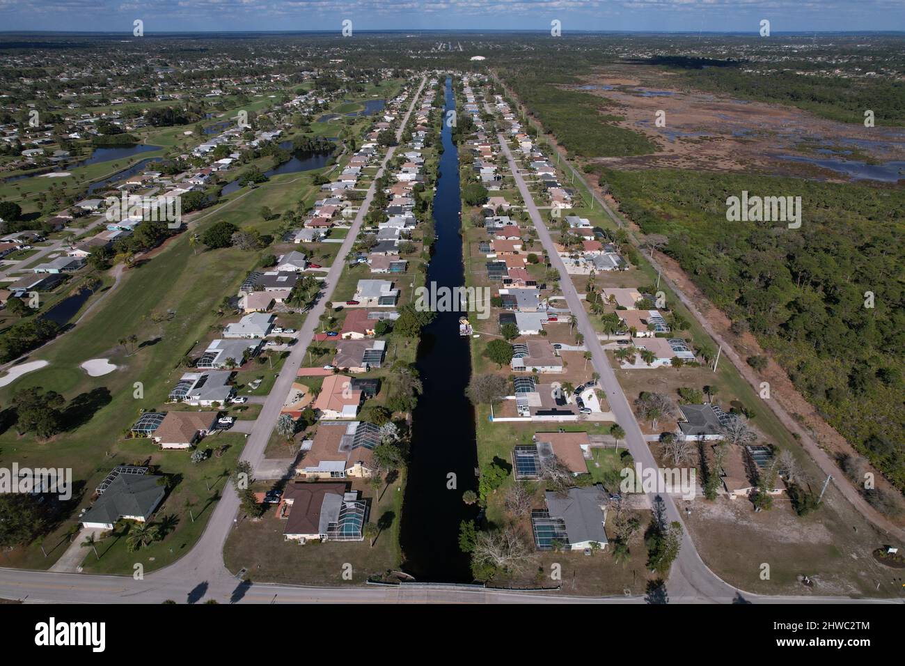 Aerial view of Annapolis Ln and Caddy Road separated by a canal with a view of the Hills Fairway golf coarse to the left.  Rotonda West Florida USA. M Stock Photo