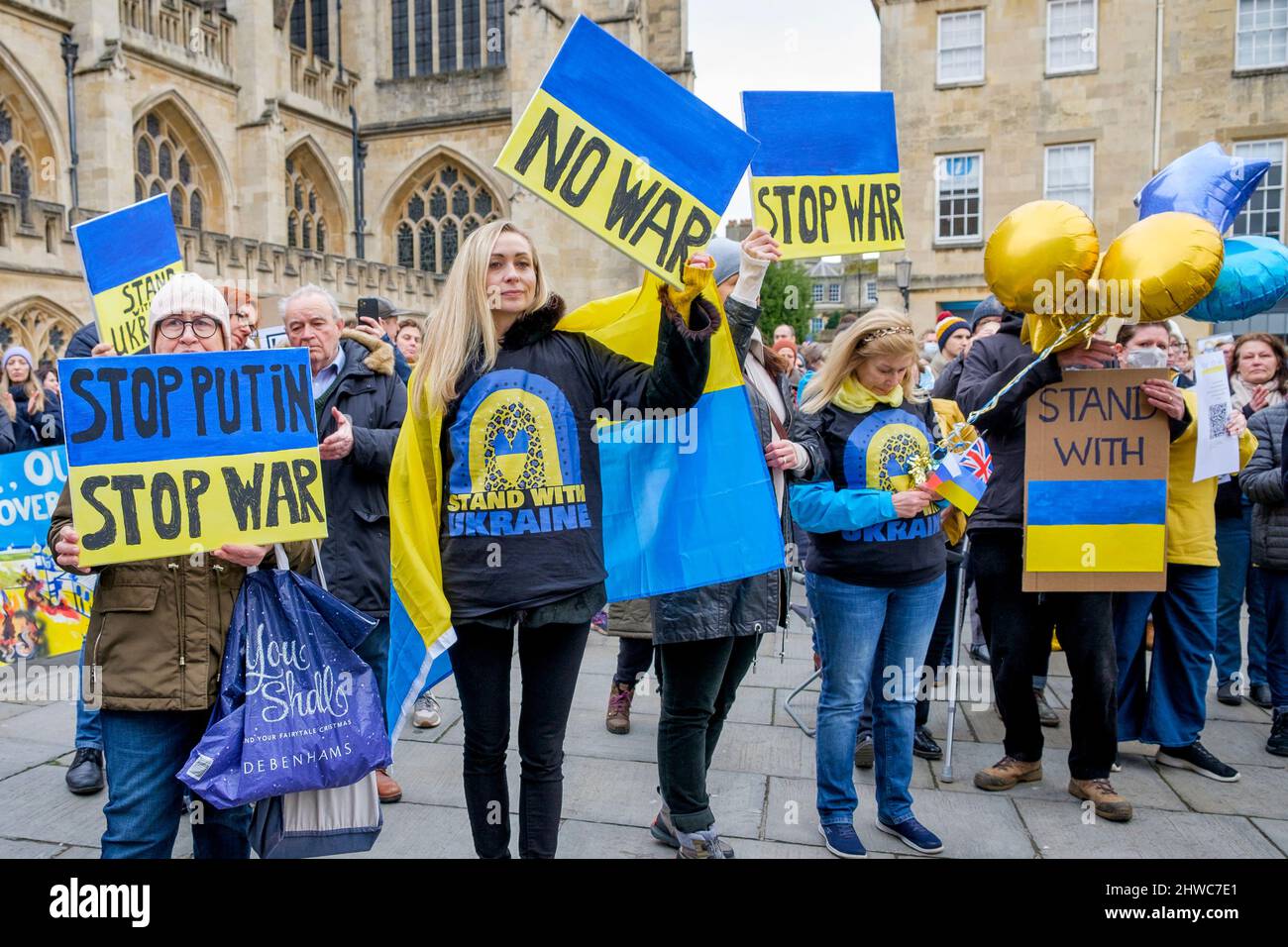 Bath, UK. 5th March, 2022. Protestors hold up stop the war placards as they listen to speeches in front of Bath Abbey during a demonstration against Russia's invasion of Ukraine. The demonstration was organised in order to allow local people to show their solidarity with Ukraine in the Russia-Ukraine war and to condemn Putin's actions. Credit: Lynchpics/Alamy Live News Stock Photo
