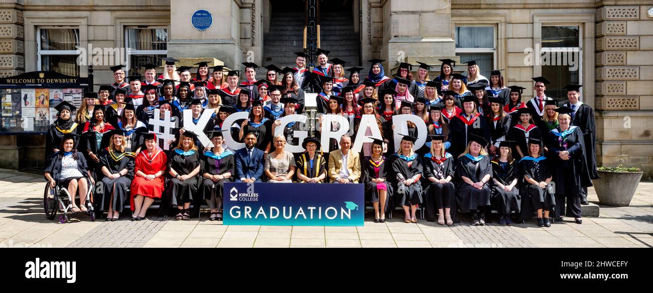 Graduates posing for their official photograph outside Dewsbury Town Hall on their graduation day ceremony. This formal event where graduands (before) Stock Photo