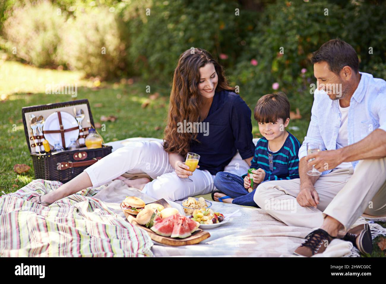 Enjoying their family picnic. Shot of a family enjoying a picnic together. Stock Photo