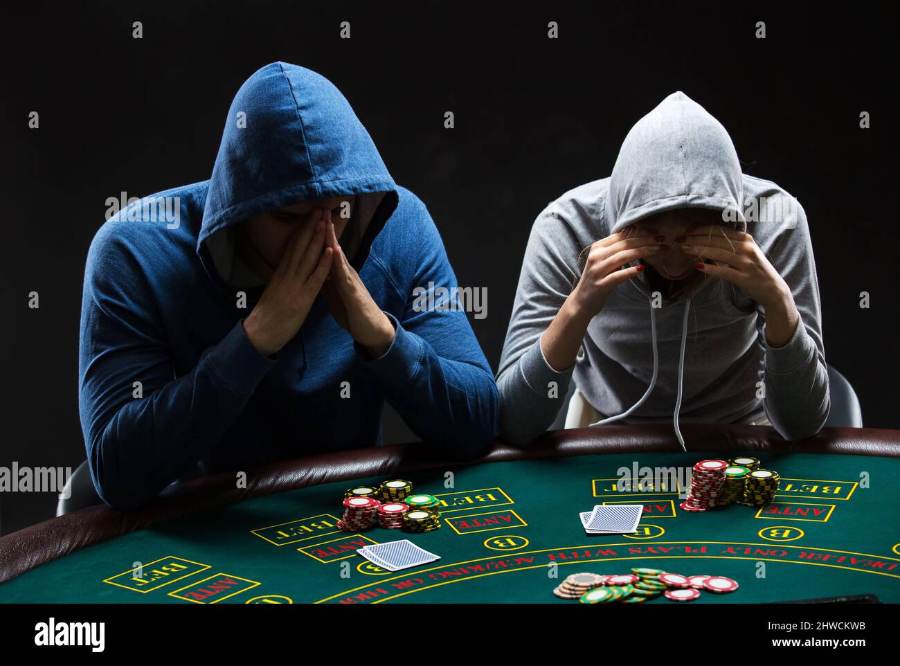Two professional poker players sitting at a table Stock Photo - Alamy