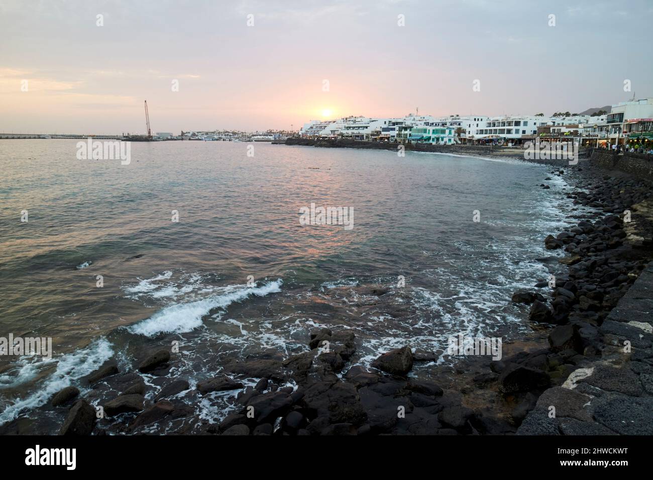 beach and coastal promenade in the evening at sunset playa blanca lanzarote canary islands spain Stock Photo