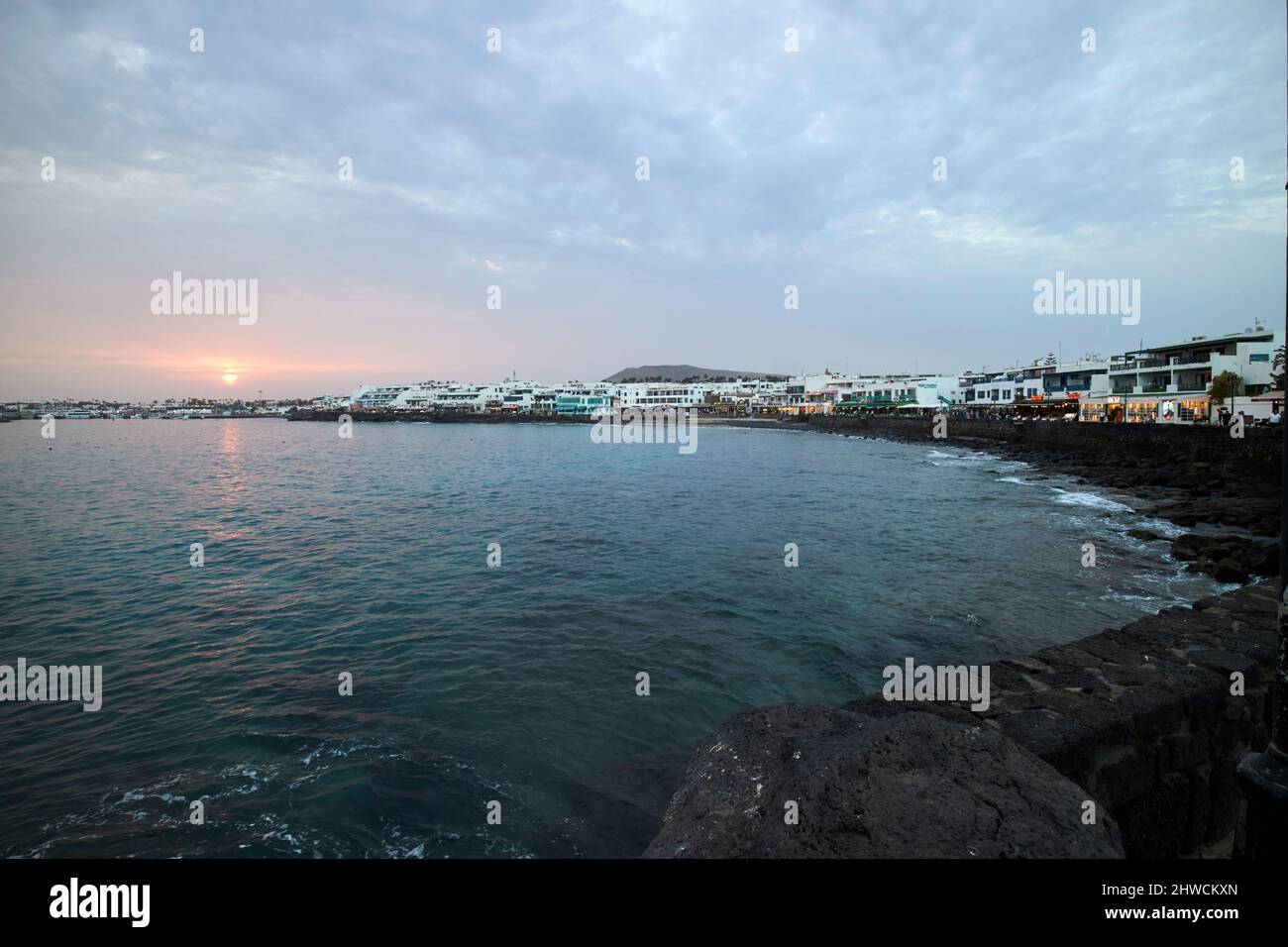 beach and coastal promenade in the evening at sunset playa blanca lanzarote canary islands spain Stock Photo