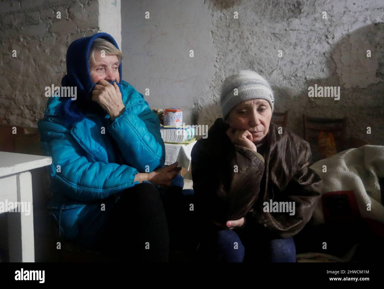 People gather in a bomb shelter in the separatist-controlled settlement of Rybinskoye during Ukraine-Russia conflict in the Donetsk region, Ukraine March 5, 2022. REUTERS/Alexander Ermochenko Stock Photo