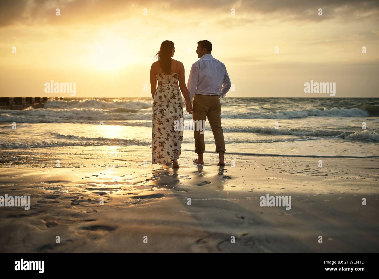 Side view of young romantic wedding couple holding face to face outdoors  Stock Photo - Alamy