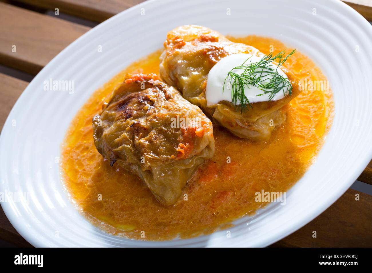 Cabbage rolls in cabbage leaves with sour cream, dish of Eastern