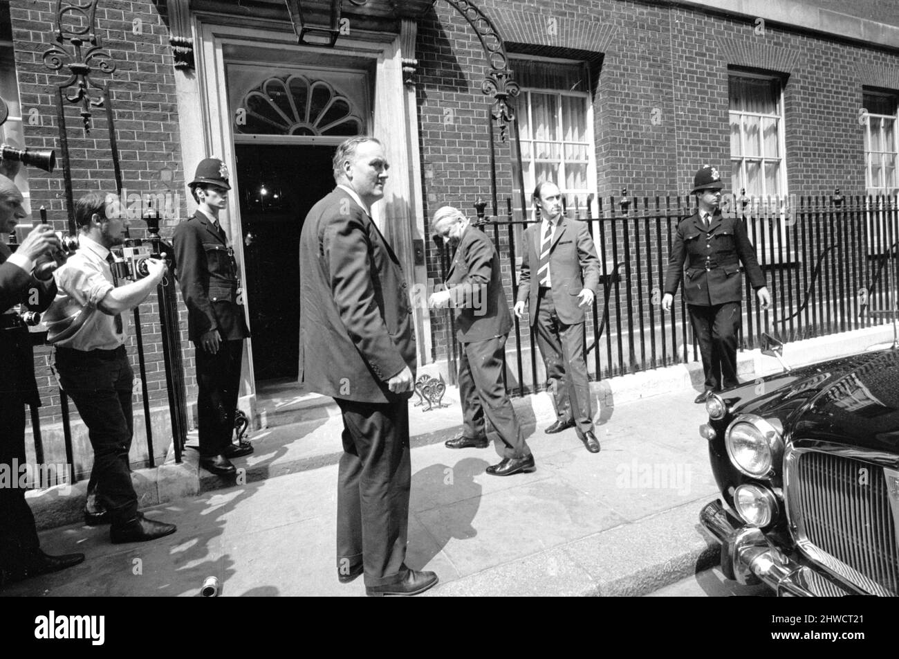 Prime Minister Edward Heath is rushed back inside Number 10 Downing Street watched by Willie Whitelaw after being covered in paint by art editor Angela Hilary Weight. 25th June 1970. Stock Photo