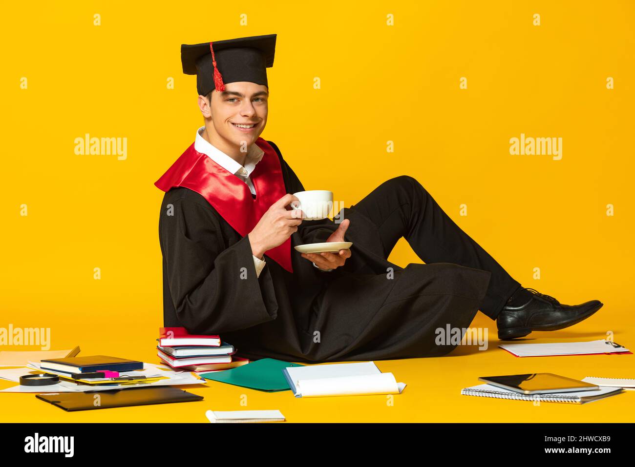 Student drinking coffee sitting around page saying the word ideas Stock