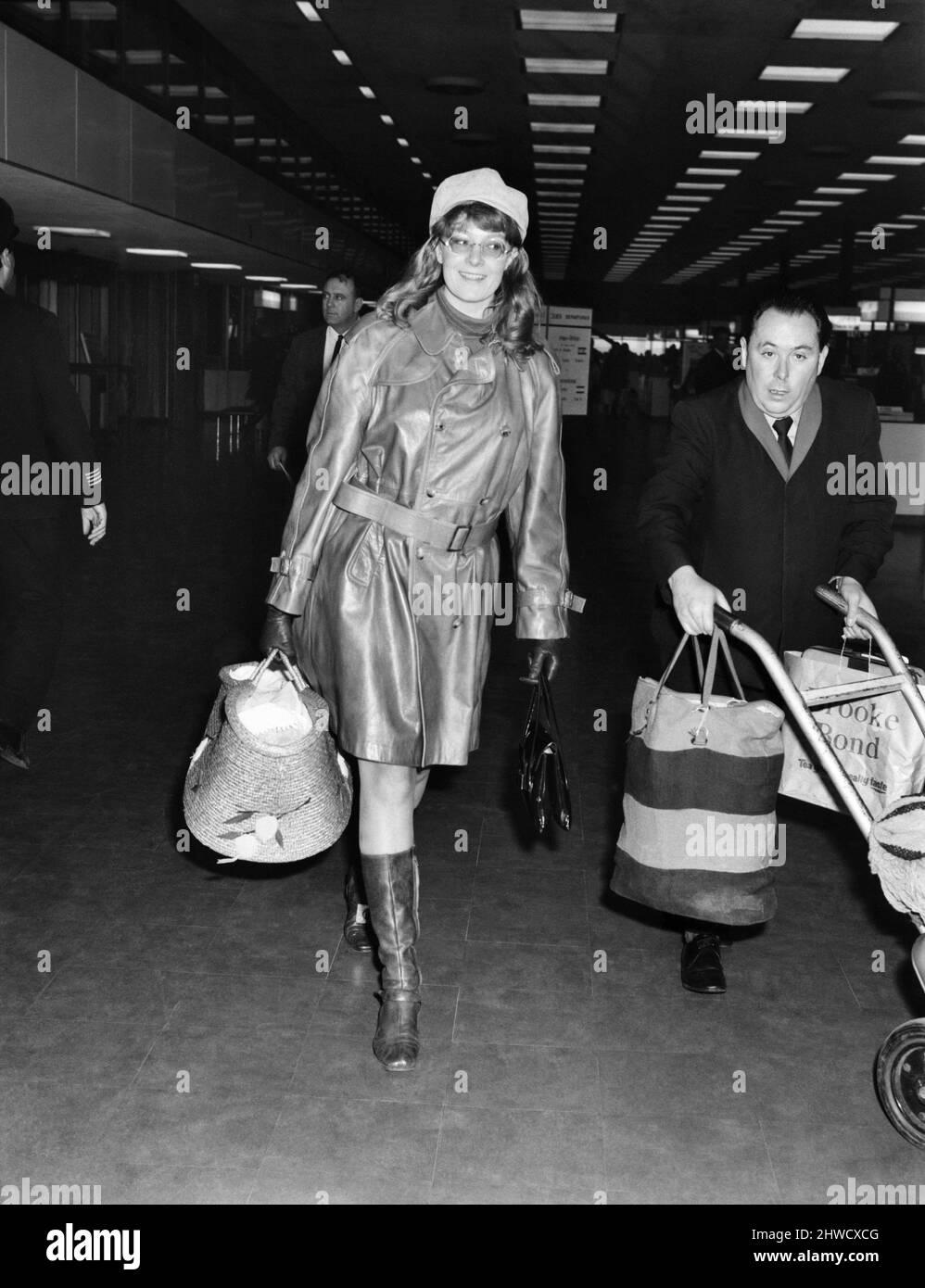 Entertainment. Film. Actress Vanessa Redgrave left Heathrow Airport  to fly to Madrid to be with her son's father Franco Nero. She was carrying her baby Carlo in what looked like a large raffia shopping basket. Vanessa Redgrave wearing all-leather clothes, with her baby Carlo in the large basket at Heathrow. November 1969 Z11252 Stock Photo
