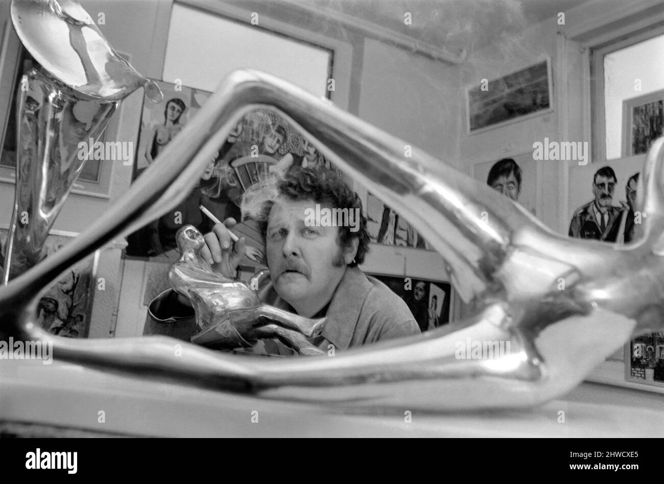 Liverpool art sculptor Arthur Dooley is proud of his latest work,  a 12 inch high brass model of the late Sir Winston Churchill.  December 1969   Z11828-002 Stock Photo