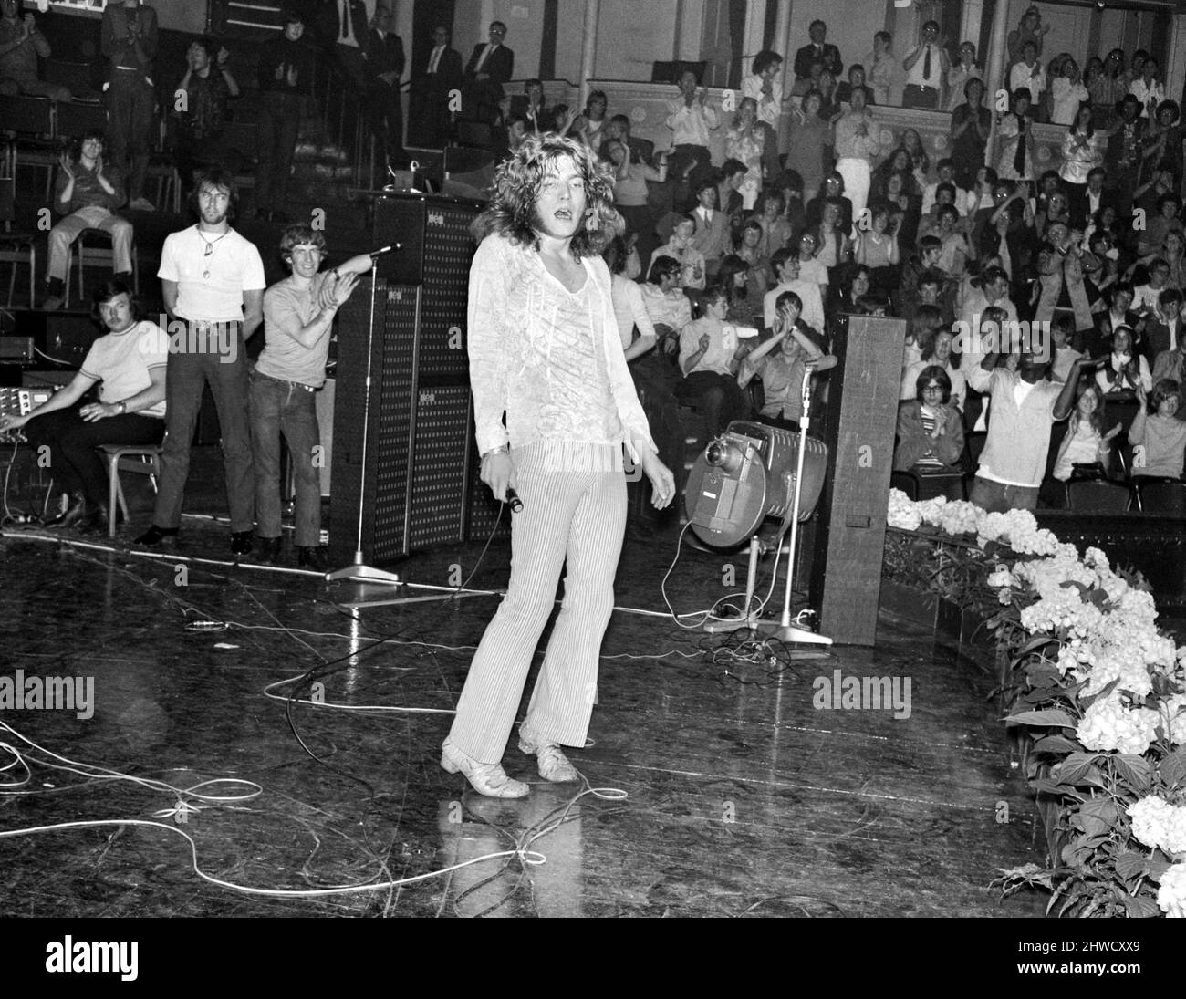 Lead singer Robert Plant of Led Zeppelin rock group performing on stage