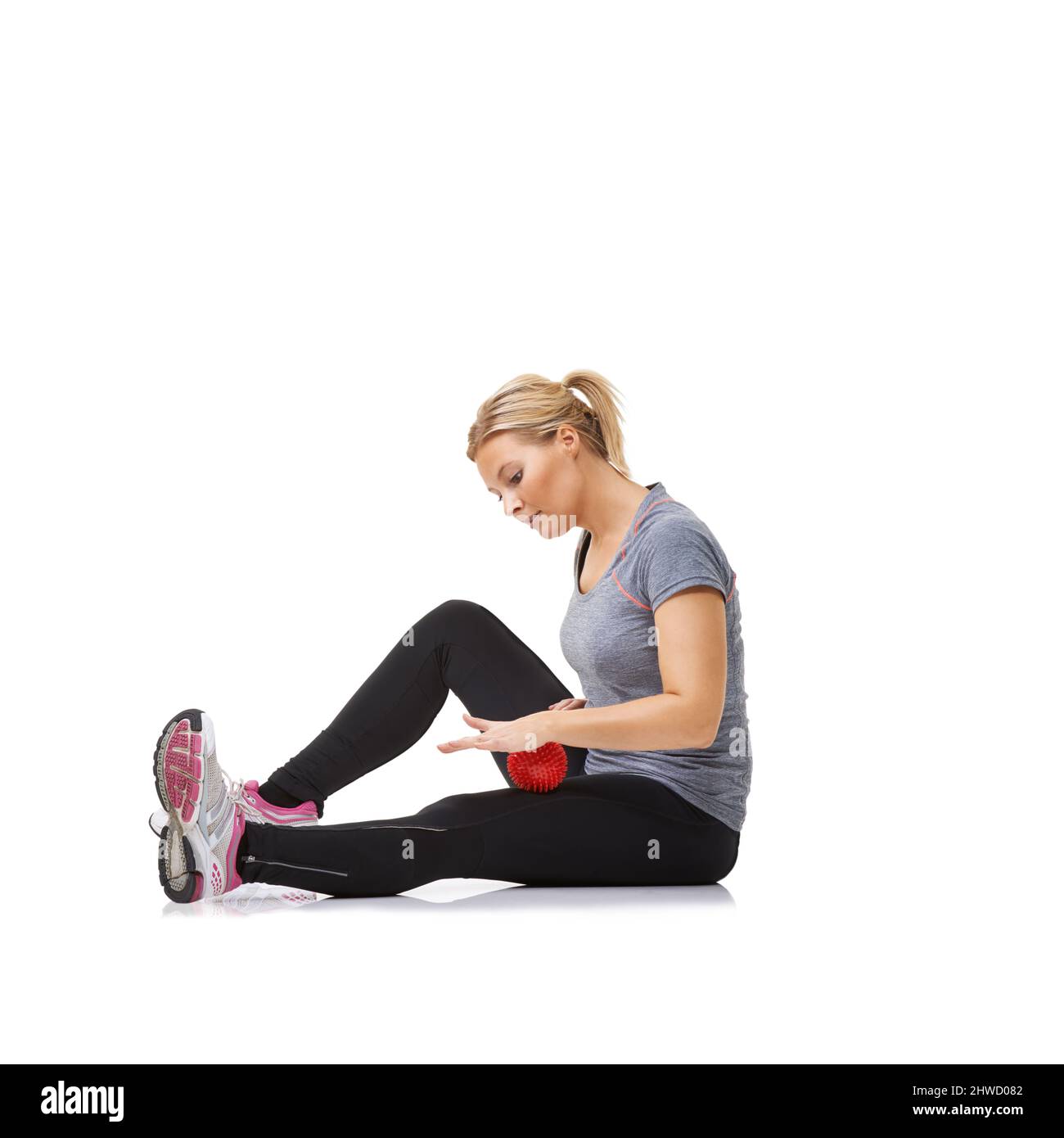 Toning her legs. A young woman getting in shape using an exercise ball. Stock Photo