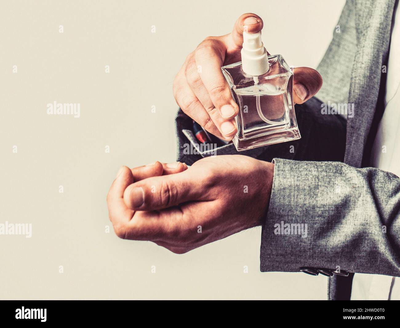 Fragrance smell. Men perfumes. Fashion cologne bottle. Man holding up