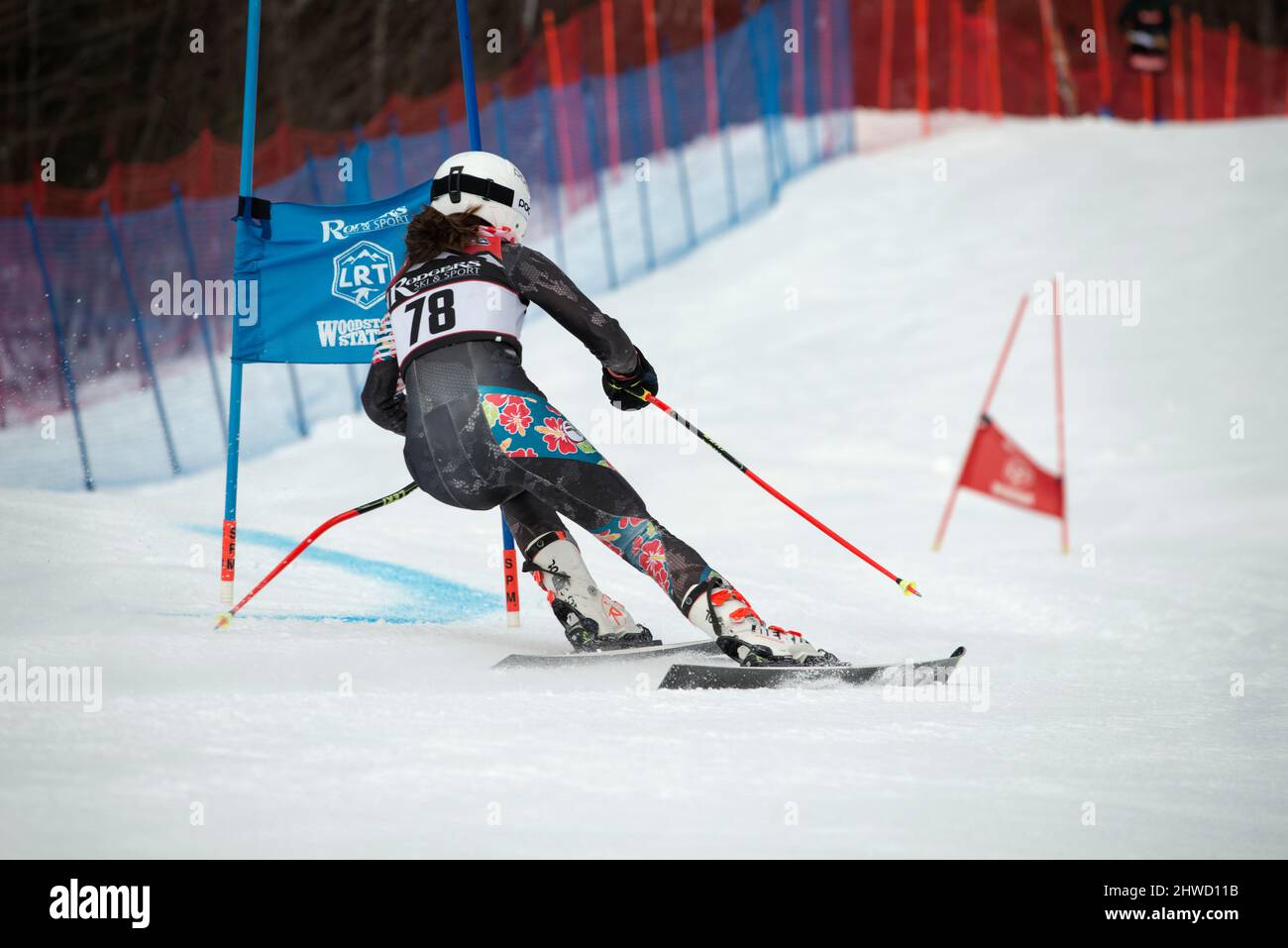 Female ski racer on the Giant Slalom course during the 2022 Lafoley New Hampshire Alpine Racing Association (NHARA) State Championship at Loon Mountain, NH. Stock Photo