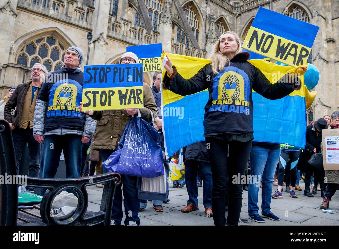Bath, UK. 5th March, 2022. Protestors hold anti-Putin and stop the war placards as they listen to speeches in front of Bath Abbey during a demonstration against Russia's invasion of Ukraine. The demonstration was organised in order to allow local people to show their solidarity with Ukraine in the Russia-Ukraine war and to condemn Putin's actions. Credit: Lynchpics/Alamy Live News Stock Photo