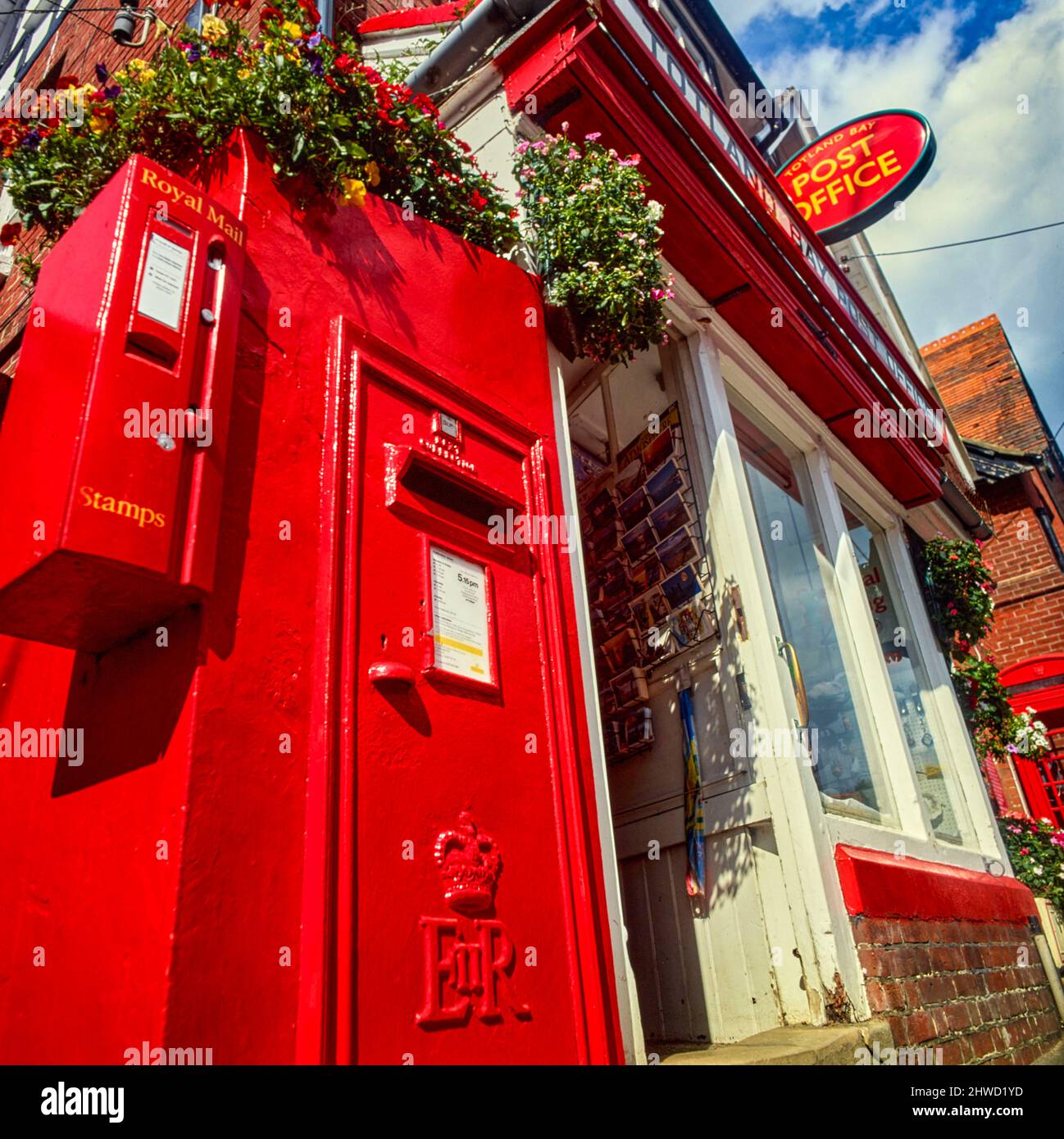 Street furniture featuring a Red English posting box outside of a