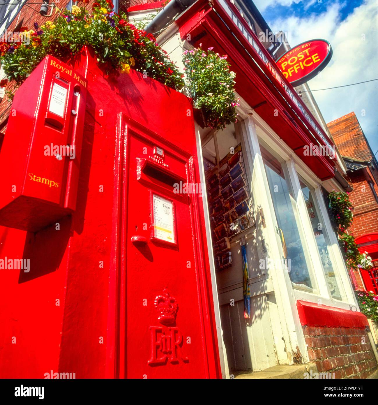 Street furniture featuring a Red English posting box outside of a