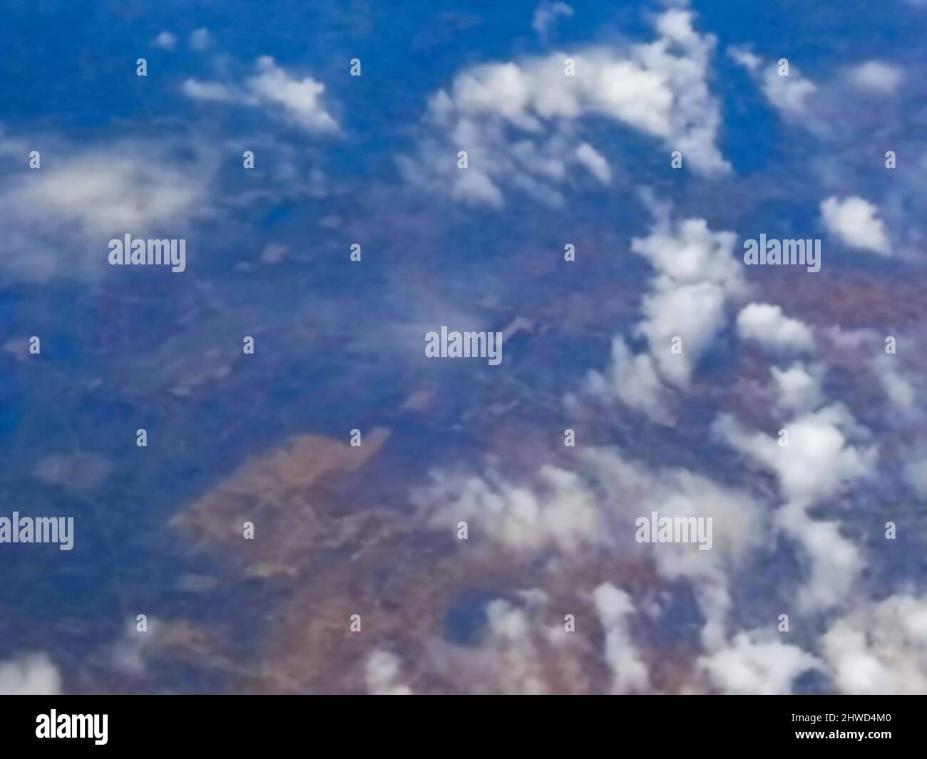 Blurred image of nice white clouds in the atmosphere, image shot in the sky from aeroplane. Nature stock image. Stock Photo