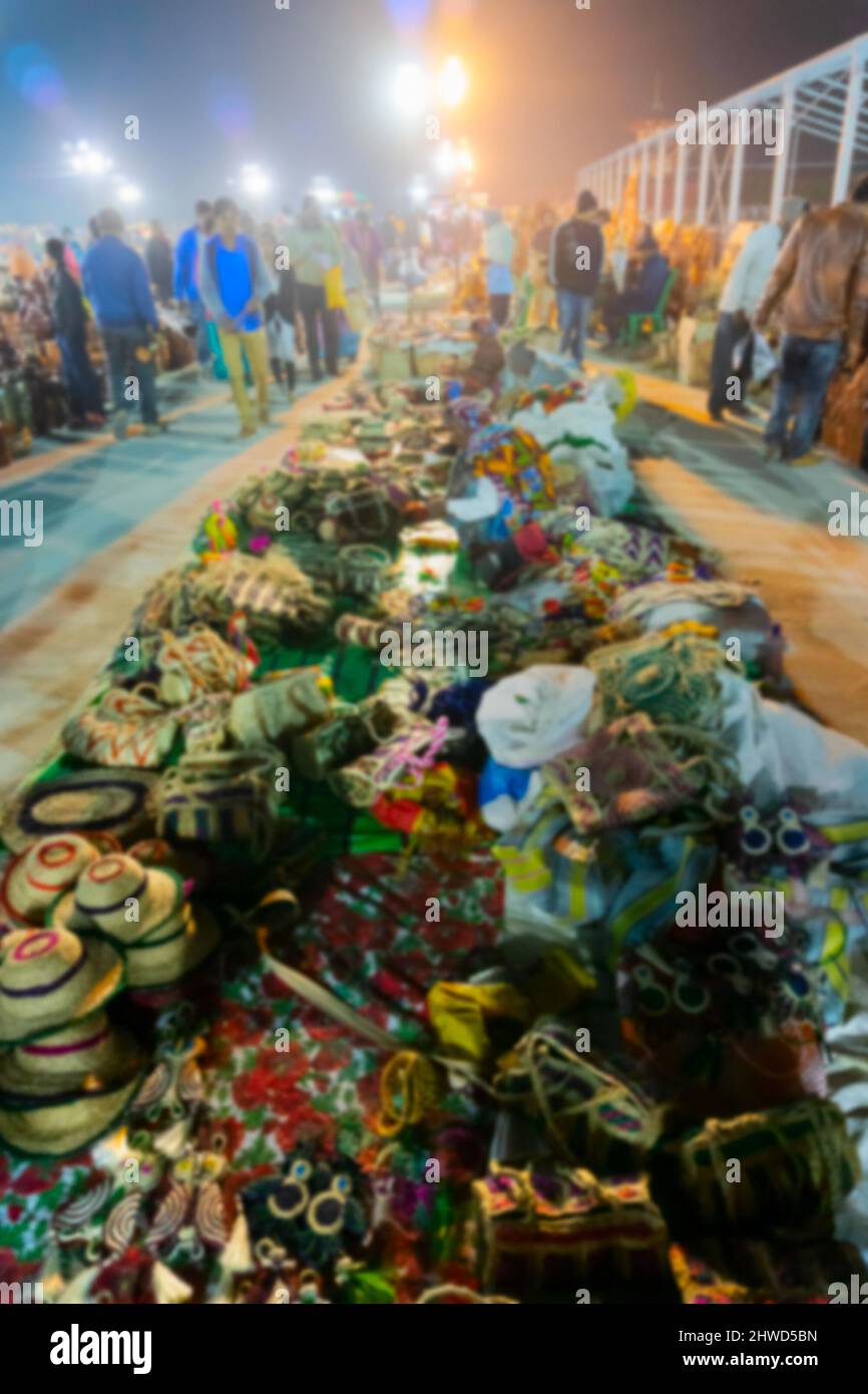 Blurred image of Kolkata, West Bengal, India. Handmade jute hats and other products, handicrafts for sale at night during Handicraft Fair in Kolkata. Stock Photo