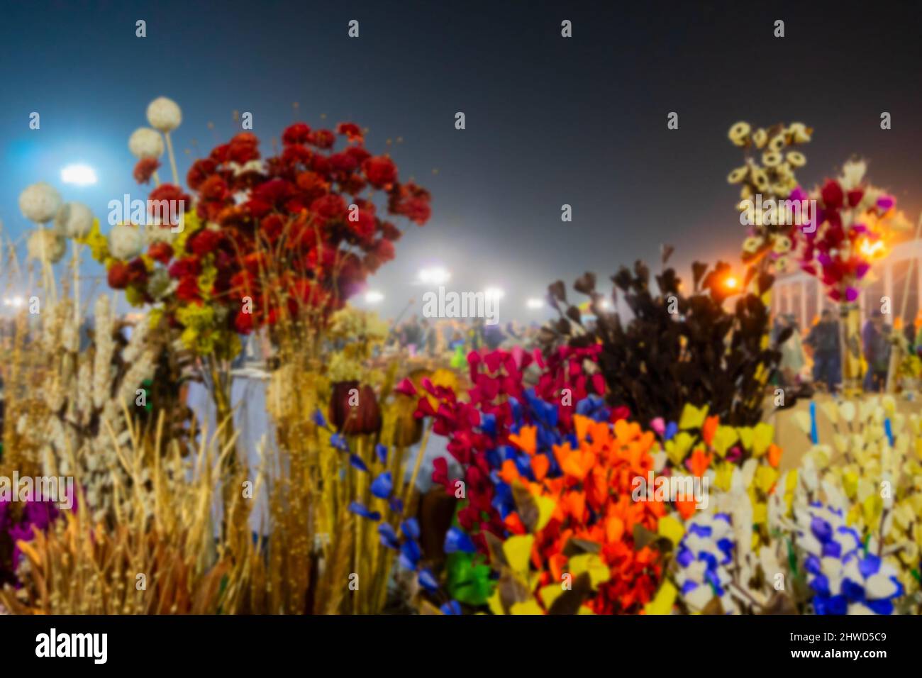Blurred image of Thermocol made artificial colored flowers and plants