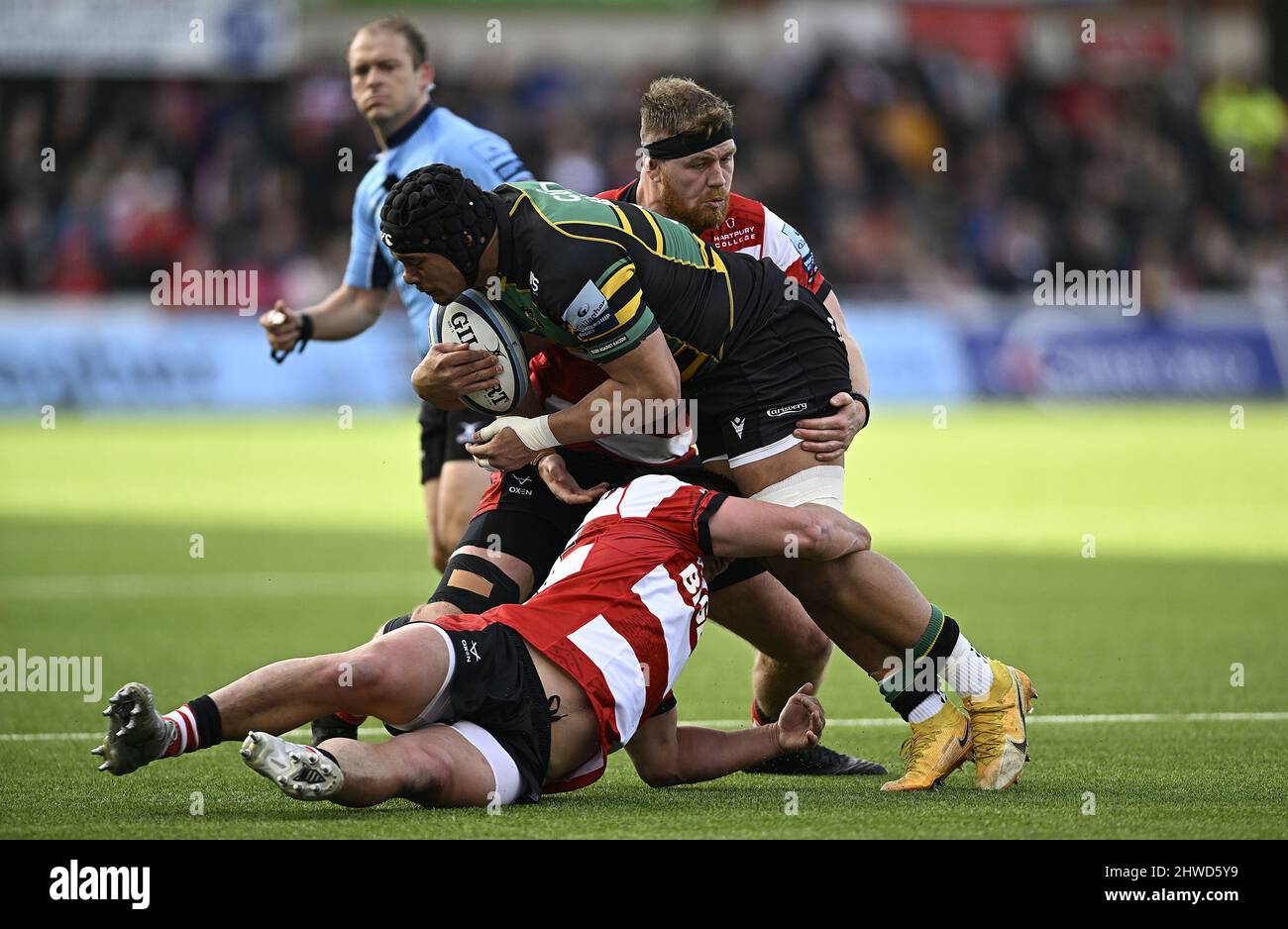 Gloucester, United Kingdom. 05th Mar, 2022. Premiership Rugby. Gloucester Rugby V Northampton Saints. Kingsholm Stadium. Gloucester. Juarno Augustus (Northampton Saints) is tackled by Santiago Socino (Gloucester Rugby, on ground) and Harry Elrington (Gloucester Rugby) during the Gloucester Rugby V Northampton Saints Gallagher Premiership rugby match. Credit: Sport In Pictures/Alamy Live News Stock Photo