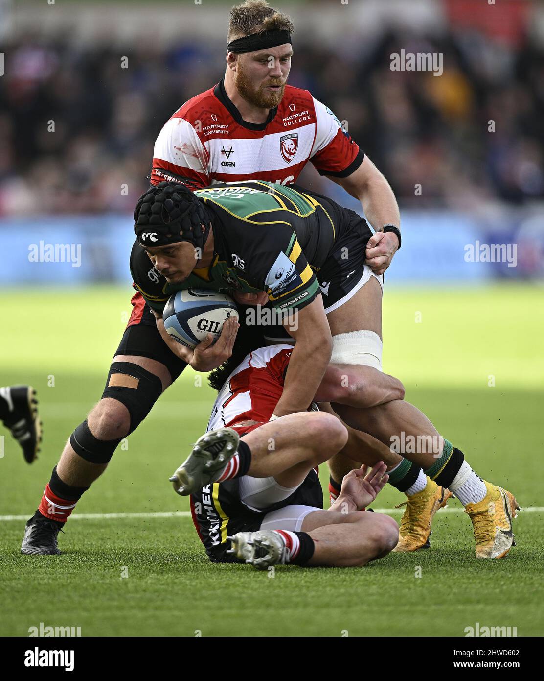 Gloucester, United Kingdom. 05th Mar, 2022. Premiership Rugby. Gloucester Rugby V Northampton Saints. Kingsholm Stadium. Gloucester. Juarno Augustus (Northampton Saints) is tackled by Santiago Socino (Gloucester Rugby, on ground) and Harry Elrington (Gloucester Rugby) during the Gloucester Rugby V Northampton Saints Gallagher Premiership rugby match. Credit: Sport In Pictures/Alamy Live News Stock Photo