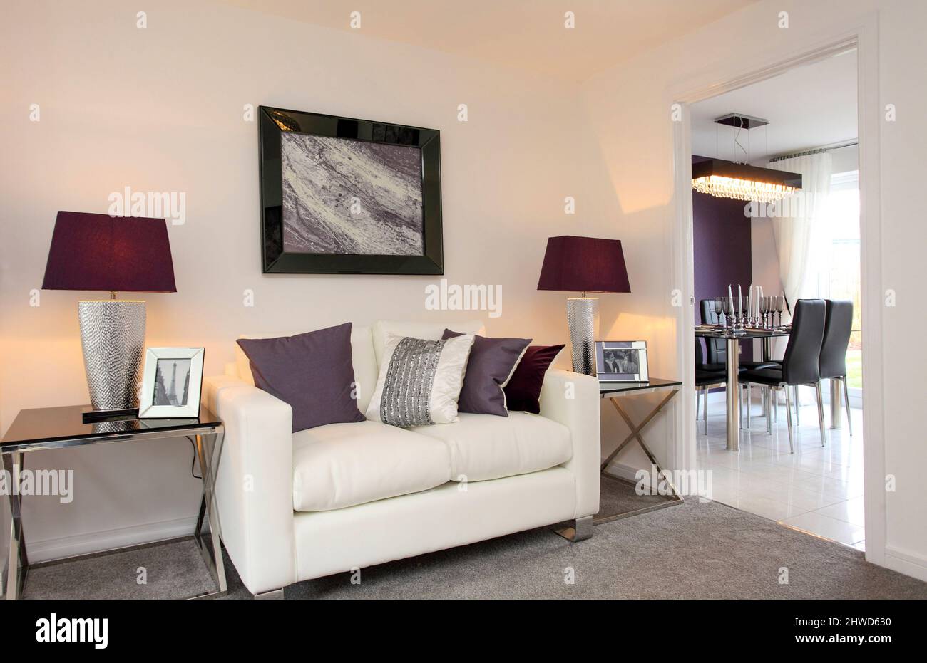 Sofa with side tables, view through to dining area in modern showhome Stock Photo
