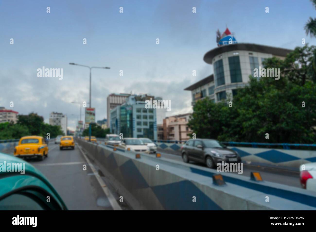 Blurred image of Kolkata, West Bengal, India. Fast moving cars passing AJC Bose road flyover, busy city traffic of Kolkata road. Stock Photo