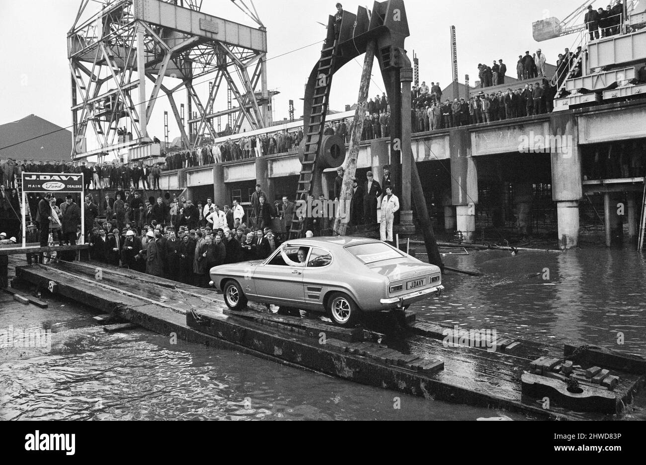 The new Ford Capri, launched in unusual manner off the slipway at the shipbuilding yard of Cammell laird in Birkenhead, Wirall.The car was launched into the Mersey with a bottle of champagne smashed onto the the bumper by Miss Liverpool Margaret Ashcroft.  5th February 1969. Stock Photo