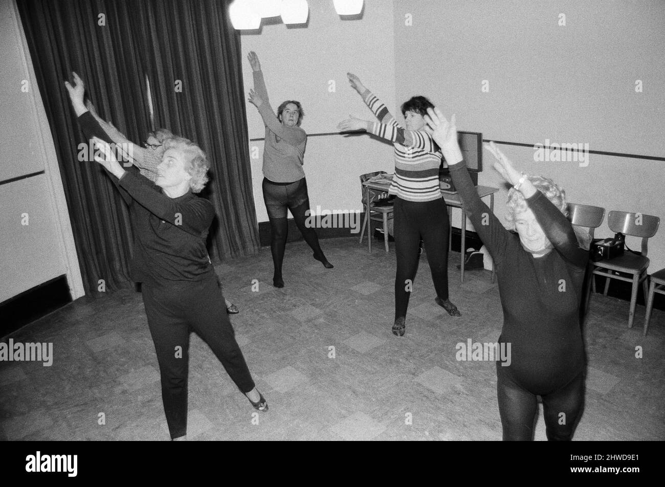 Cornwall's most amazing grandmother, Mrs Mary Wyatt (75 next April) dances her way into the new decade of the 1970s, clad in black dancing tights showing a class of women how to do energetic and athletic arm and leg stretches to music. Mrs Wyatt held her first Keep Fit class of the 1970s at the Community Rooms at the Guildhall in St Ives, Cornwall. 2nd January 1970.Cornwall's most amazing grandmother, Mrs Mary Wyatt (75 next April) dances her way into the new decade of the 1970s, clad in black dancing tights showing a class of women how to do energetic and athletic arm and leg stretches to mus Stock Photo