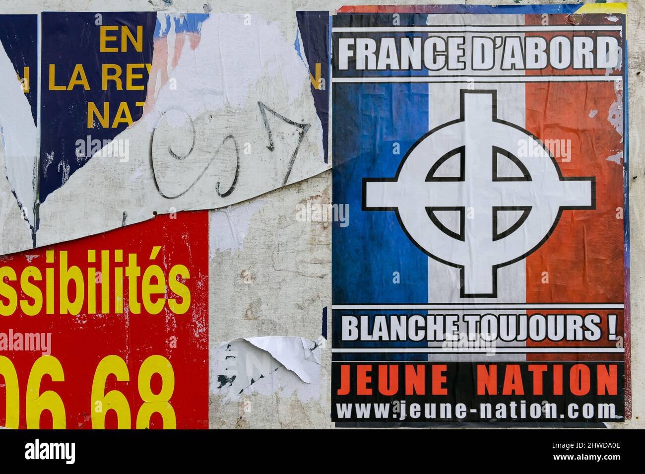 An extreme right-wing poster of the Jeune Nation group headed by Yvan Benedetti is seen pasted along the Route Nationale 7 in the Var department.Many posters of Eric Zemmour and extreme right-wing groups appeared in the villages of Var around Toulon. These collages correspond to the announcement of an important political meeting on March 06, 2022 in Toulon where the candidate Eric Zemmour, of the Reconquete! party, hopes to gather more than 7000 people and should announce the rallying of Marion Maréchal - Le Pen behind his candidature. Stock Photo