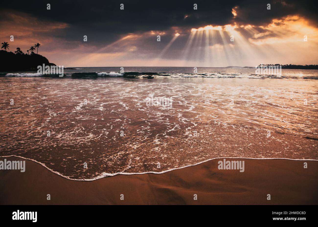 beautiful sunset over tropical beach Stock Photo - Alamy