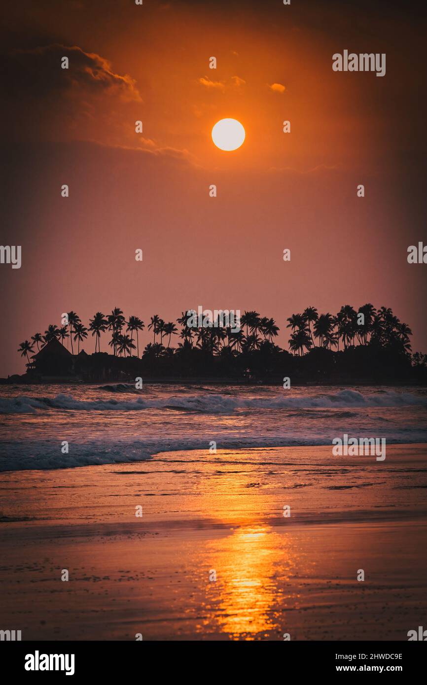 beautiful sunset over tropical beach Stock Photo - Alamy