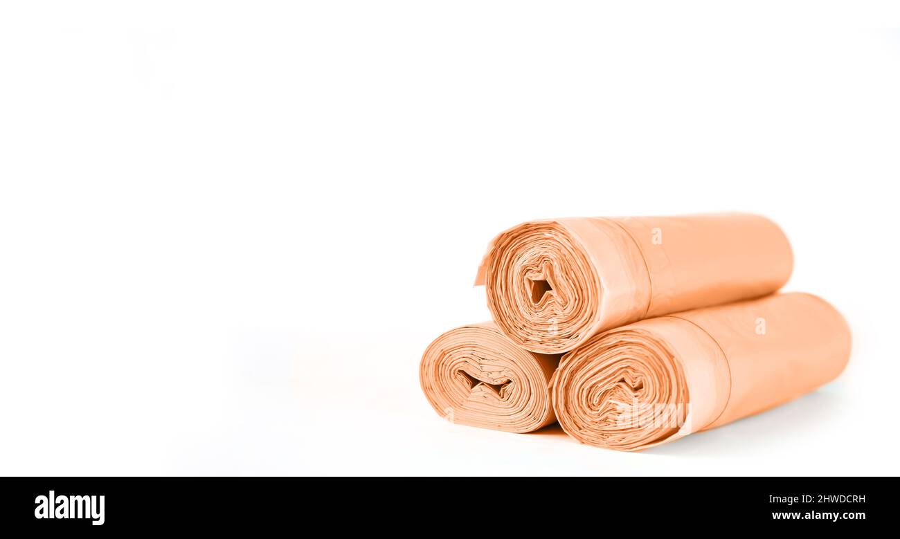 Orange rolls of garbage trash bin bags isolated on white background with copy space Stock Photo