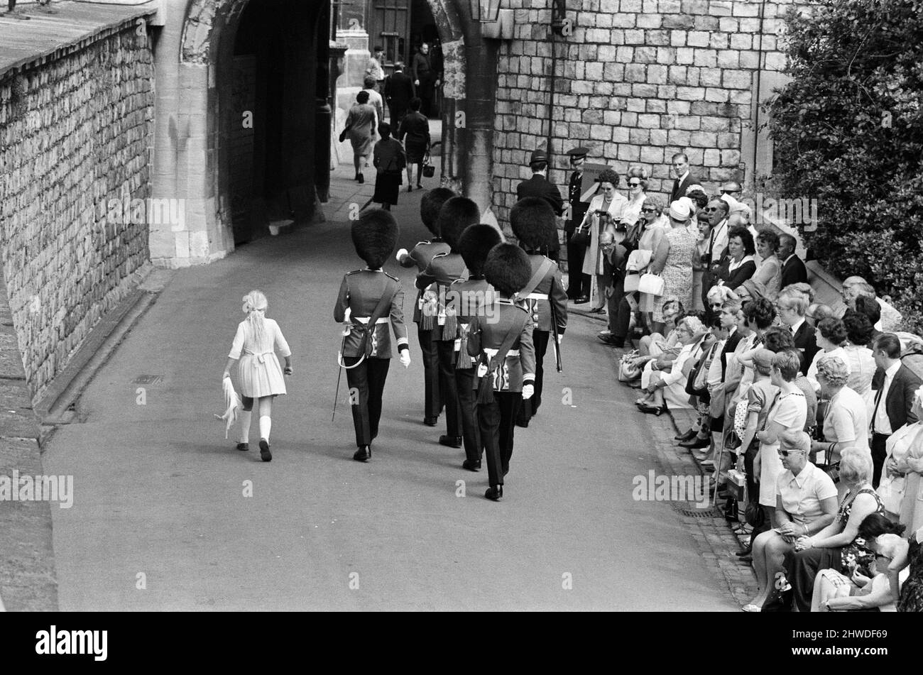 Garter Procession at Windsor Castle. A little girl joins the Guards as they march into Windsor Castle. 15th June 1970. Stock Photo