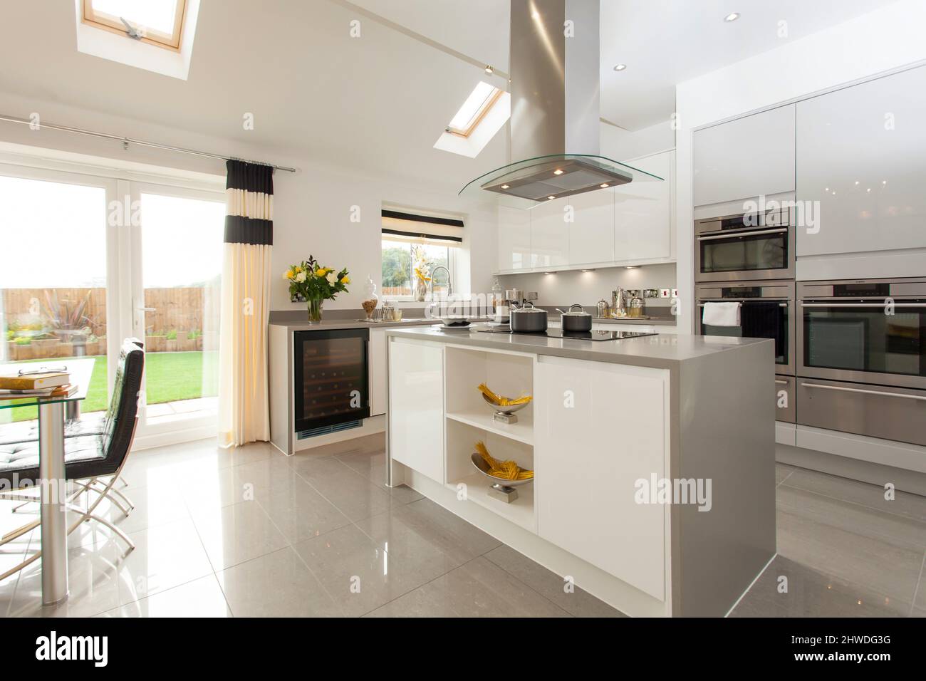 Kitchen with centre island cooking area, induction hob and cooker hood