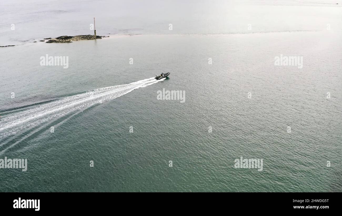 Aerial view of white motorboat and red water biking sailing on the sea ...