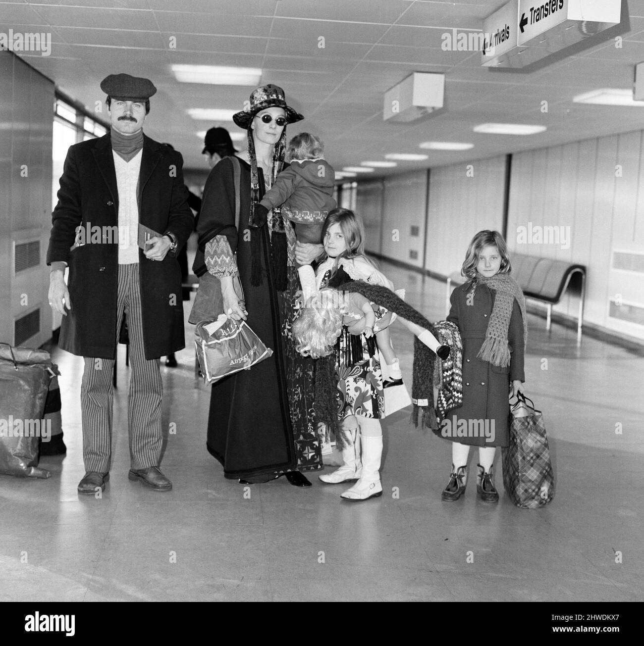 Off on a week's holiday to Rome is Vanessa Redgrave with children Natasha, 7, Joely, 5, Carlo, 1, and Franco Nero. As they rush to catch their flight they had to be searched because the plane was going onto a security area (Middle East). Vanessa was dressed in a mauve cloak and multi coloured dress with a mauve hat, They were the last to board the place and only just made it. 26th December 1970. Stock Photo