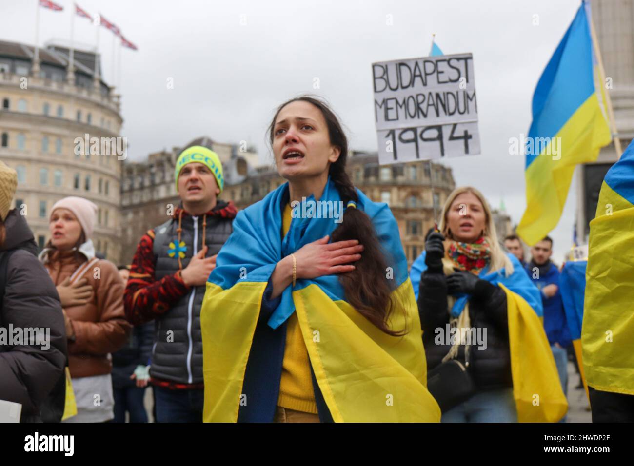 LONDON, MARCH 05 2022, Protesters sing the Ukrainian national anthem during a protest against Russia's invasion of Ukraine on Trafalgar Square. Credit: Lucy North/Alamy Live News Stock Photo