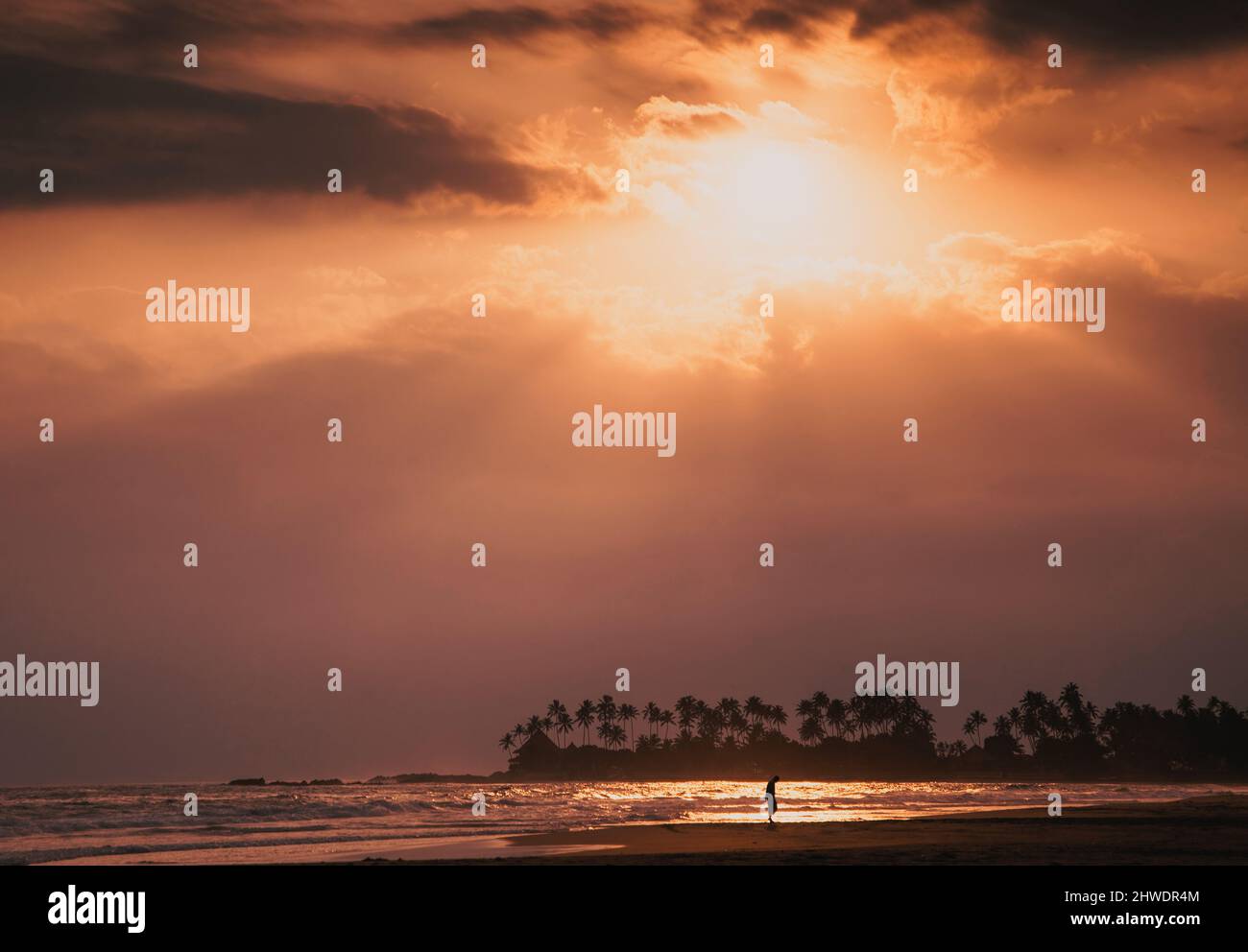 beautiful sunset over tropical beach Stock Photo - Alamy
