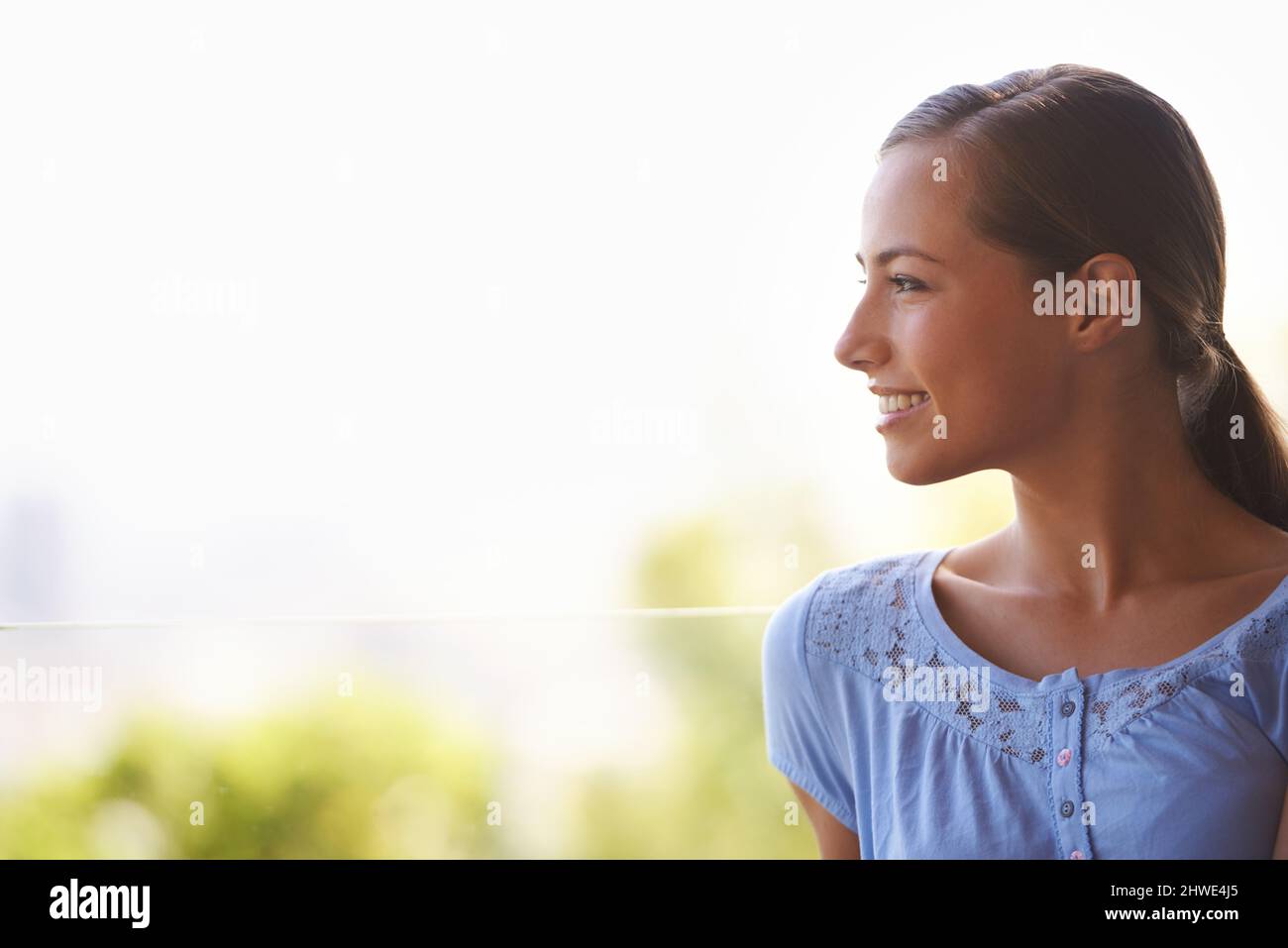 She loves the cool breeze on her face. Profile shot of a gorgeous young woman. Stock Photo