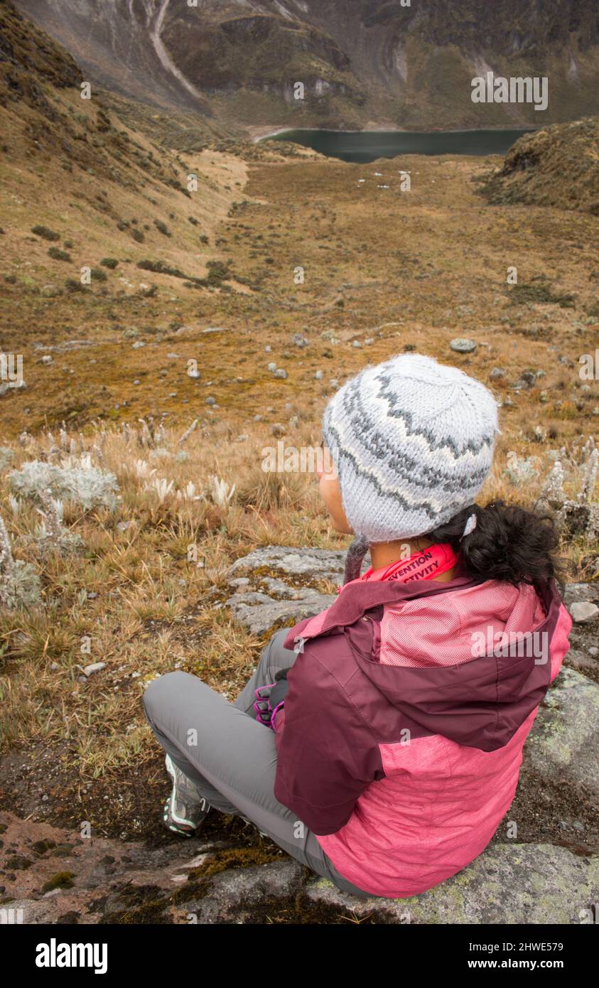 Beautiful young african american woman gazing at impressive glacier valley landscape and lake Stock Photo